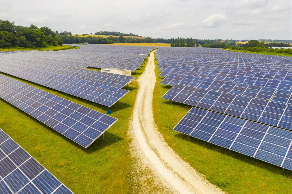 Industrial solar plant under construction — panels being installed on factory roof